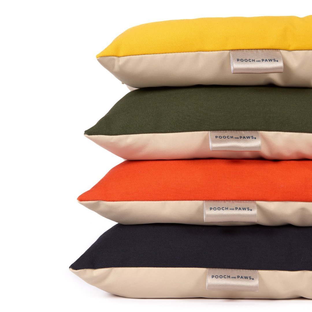 Comfort Dog Mats by Pooch and Paws stacked in blue, yellow, olive green and orange