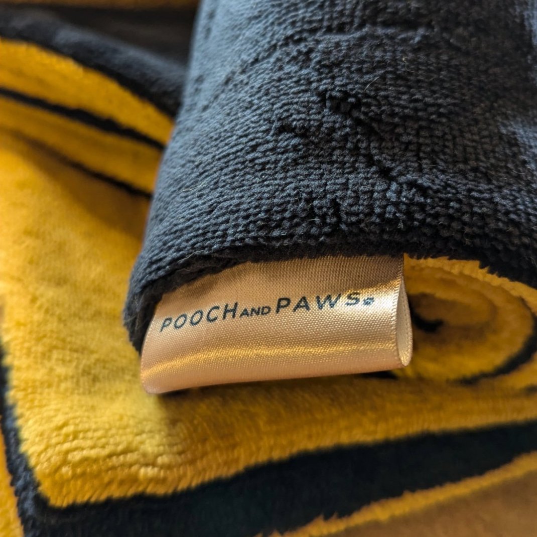 Rolled up absorbent dog towel in navy and yellow. Christmas dog gift idea. 